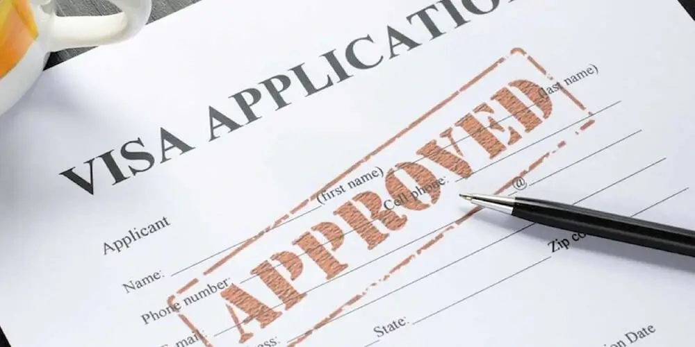 Approved visa application form with pen, symbolizing successful study abroad process with a visa consultant.