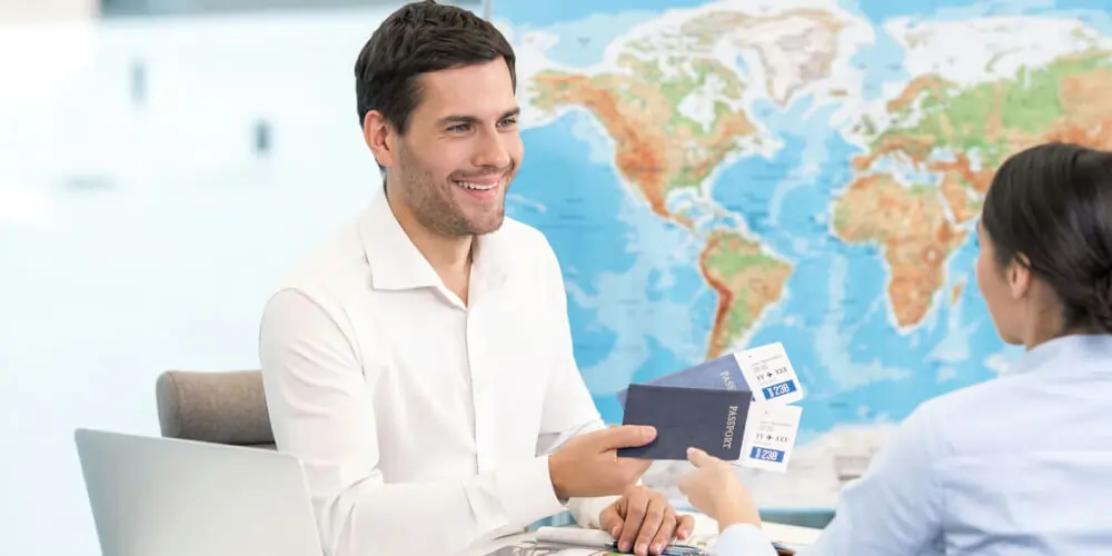 Study visa consultant handing over passports and boarding passes to student planning overseas education
