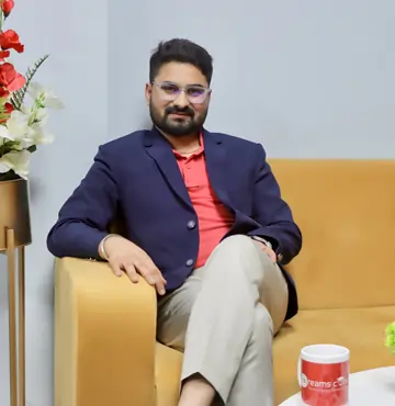 Harpreet Singh, CEO of 13 Dreams Consultant, seated confidently  in a professional 
